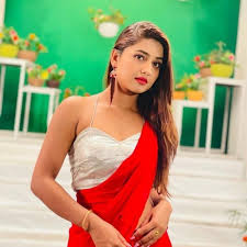 A SLIM GIRL IN RED DRESS SAREE GIVING NICE POSE